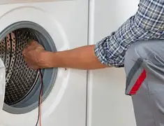Dryer repair technician diagnosing and servicing a clothes dryer in Wichita, KS