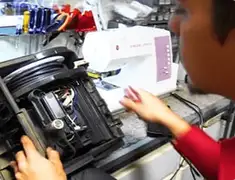 Vacuum repair technician servicing internal components on a workbench in Wichita, KS